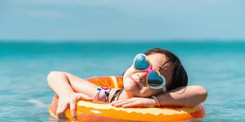 a girl with heart sunglasses floating in a tube