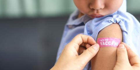bandaid that reads "I got my vaccine" on a young boy's arm
